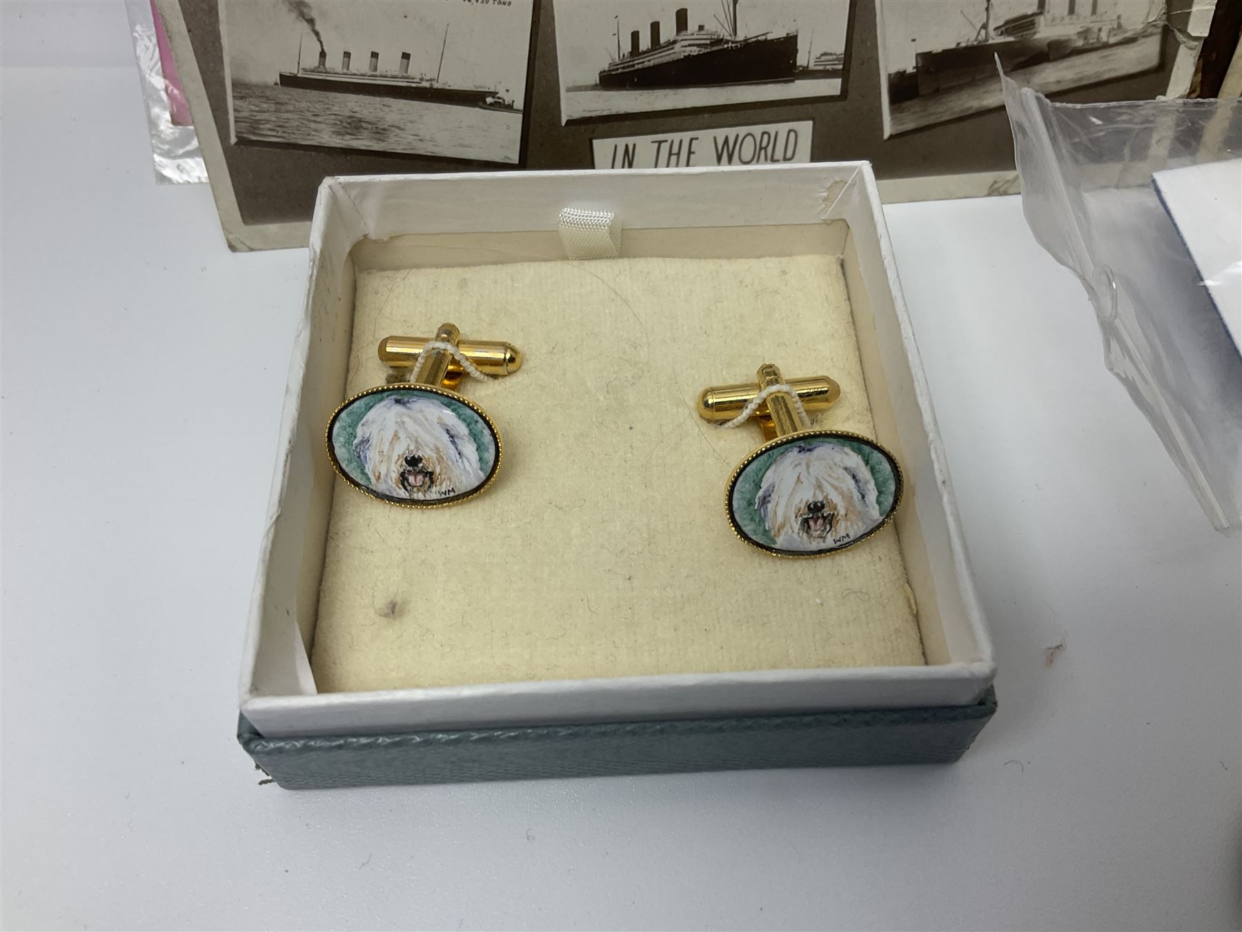 Studio Danielle Old English Sheepdog jewellery including two pairs of cufflinks, necklace and pin, together with similar belt buckle, hardstone tetradecahedron paperweight, postcards and an Imperial War Museum Falklands Conflict coin