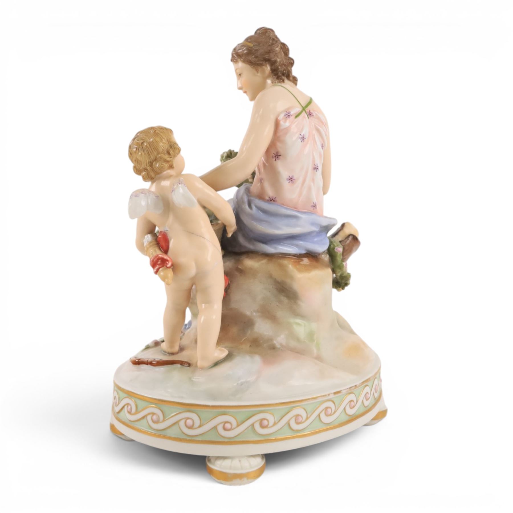 Karl Ens of Volkstedt figure group, modelled as a woman and cherub in a garden, with printed mark beneath, together with another figure modelled as a muse 