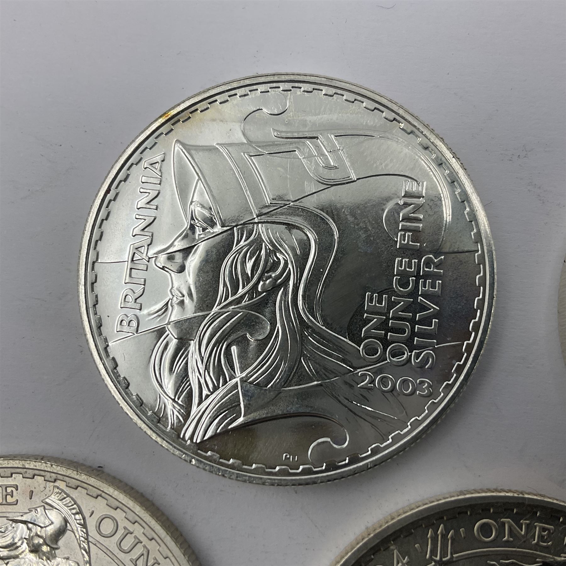 Five Queen Elizabeth II United Kingdom one ounce fine silver Britannia two pound coins dated 2002, 2003, 2004, 2005 and 2006