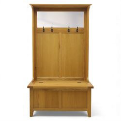 Modern light oak hall bench settle, with moulded cornice above a panelled back fitted with a row of metal coat hooks, over a hinged box seat opening to shoe storage, on tapered legs