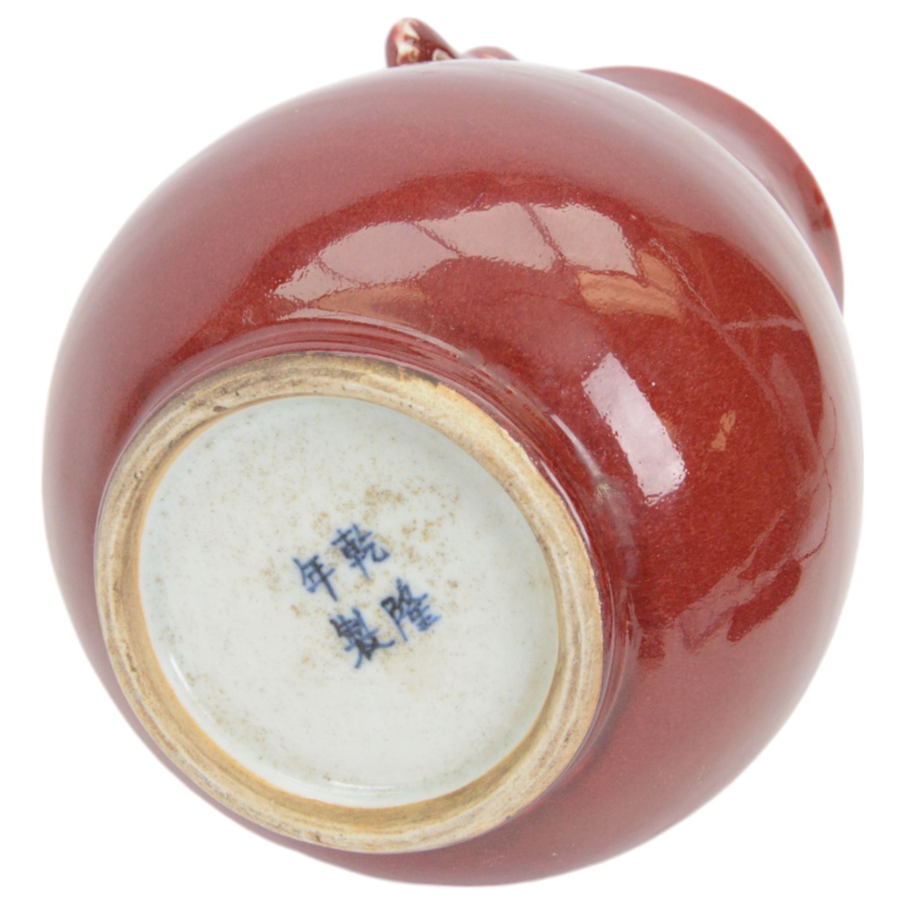 20th century Chinese sang de boeuf vase of baluster form with elephant head handles, togehter with a pair of famille rose vases decorated with floral decoration and insects, upon wooden stands   