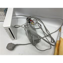 Nintendo Wii console, four controllers with cases and four nunchucks, Wii sensor bar, balance board and dance mat. Guitar hero wireless guitar for Wii and Redoctane wired guitar. Nintendo DS lite handheld gaming console, console and game cases and Guitar Hero Redoctane Guitar Grip. Selection of Nintendo Wii and Nintendo DS lite games to include Super Mario Galaxy, Guitar Hero, Wii Fit, Legend of Zelda games etc. Archos AV400 Series pocket video recorder with accessories, cradle and remote, in three boxes