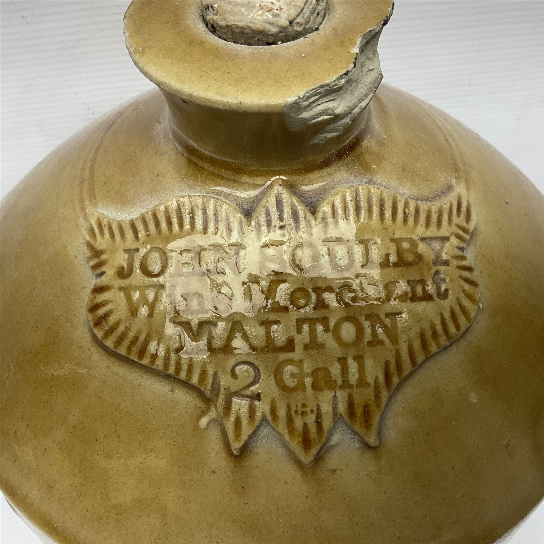 Large 2 gallon stoneware flagon, stamped 'John Soulby Wine Merchant Malton 2 Gall', together with a collection of similar stoneware jars and bottles, largest H40.5cm
