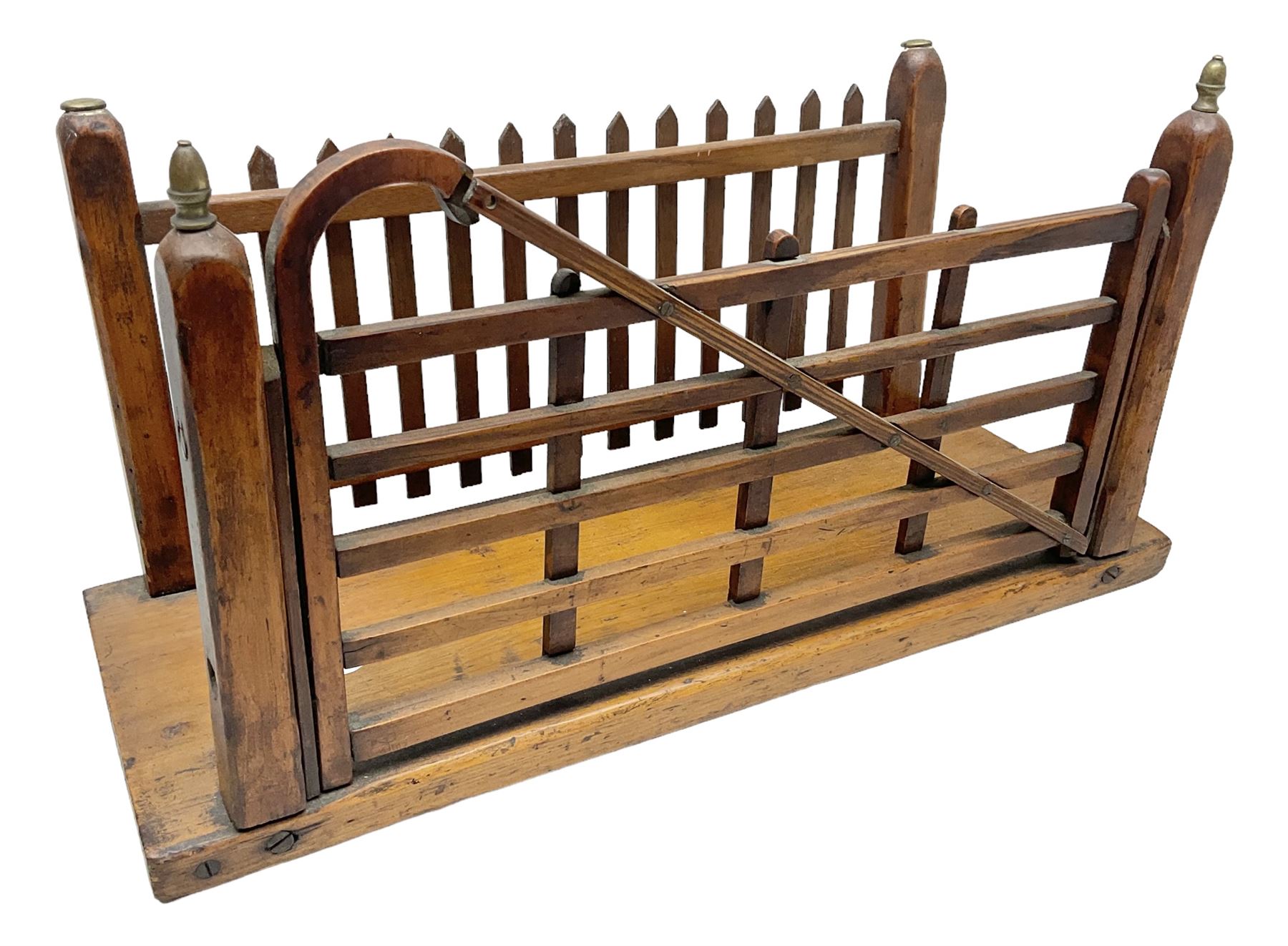 Early 20th century novelty letter rack modelled as a gate and picket fence, with brass post finials, on pine base, L43cm