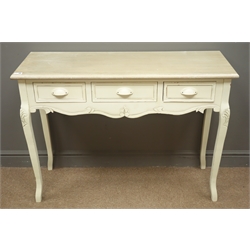  Painted French style side table, three drawers, shaped apron, fleur de lis carved cabriole legs, W110cm, H80cm, D39cm  