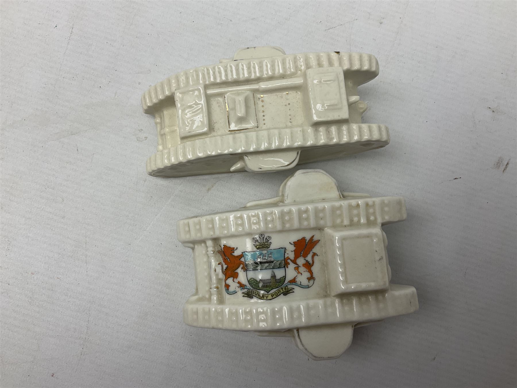 Twelve crested china models of WW1 tanks by Grafton, Arcadian and Carlton china etc with crests from Caistor Lincs, Saffron Walden, Paignton, Evesham etc  , together with a crested china model of the R.M.S Lusitania with New Brighton crest and a two-handled vase for 'The Forts Boxhill' (14)