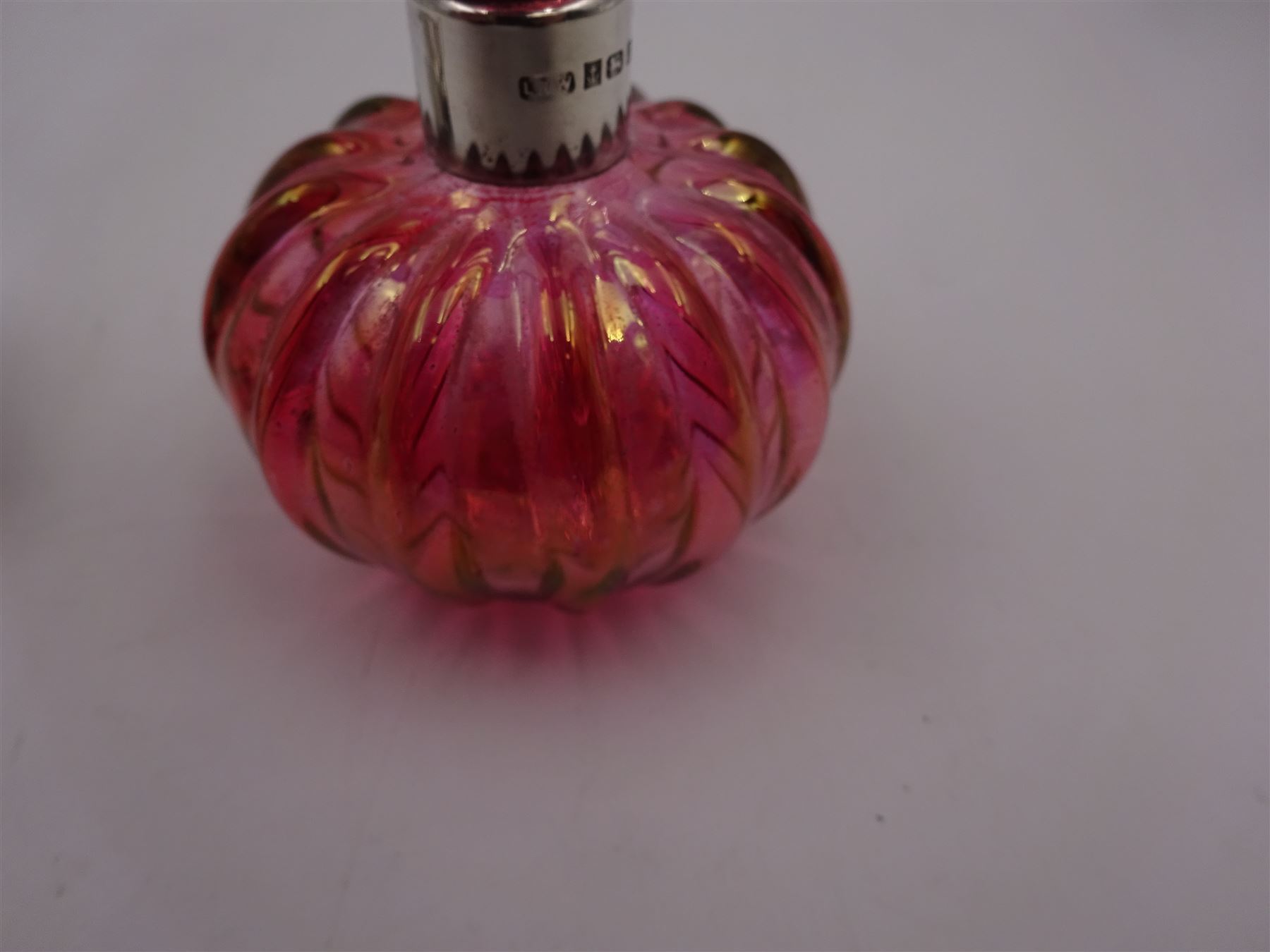 Modern novelty silver tape measure, in the form of a pig, hallmarked CME Jewellery Ltd, together with a silver mounted pink glass scent bottle, signed H. White to base, with silver collar hallmarked Laurence R Watson & Co, Birmingham 1996, scent bottle H12cm