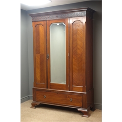  Edwardian mahogany wardrobe, projecting cornice, blind fret work above mirrored door, one drawer, bracket feet, W132cm, H202cm, D52cm  