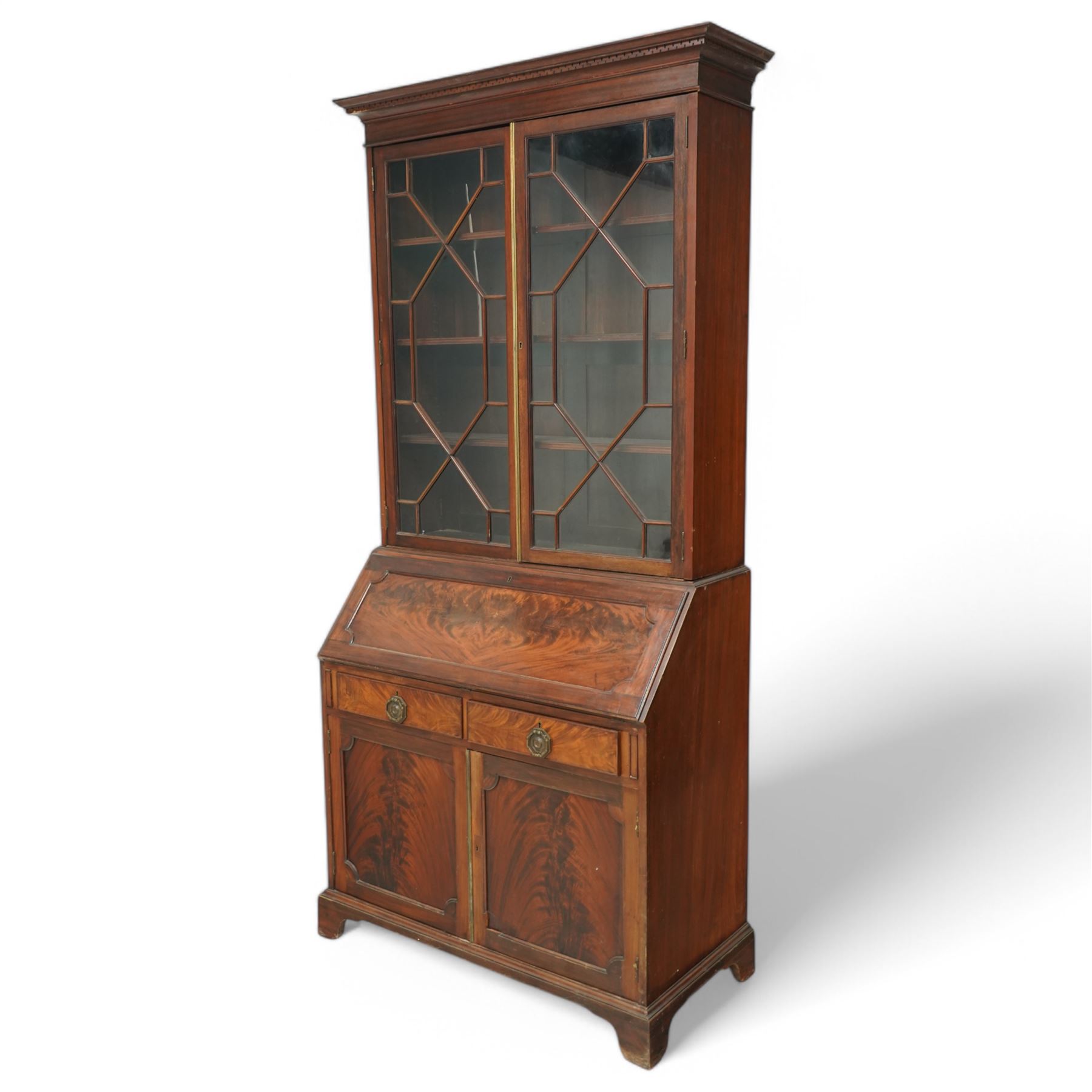 Maples & Co. Edwardian mahogany bureau bookcase, projecting moulded cornice over two astragal glazed door, panelled hinged lid over two drawers and double cupboard, on bracket feet
