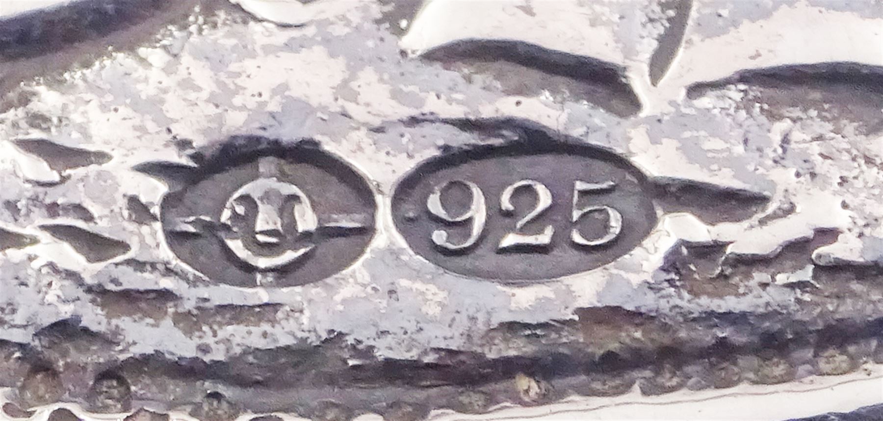 Late 19th century German Hanau silver box, of shaped rectangular form, embossed throughout, the hinged cover decorated with a central oval panel depicting a genre scene with musicians, the corners detailed with masks, the sides detailed with conforming figures and musical trophies, opening to reveal a gilt interior, with Hanau marks for Neresheimer & Sohne, and hallmarked B Muller & Son, London import 1907, approximate weight 3.32 ozt (103.4 grams)