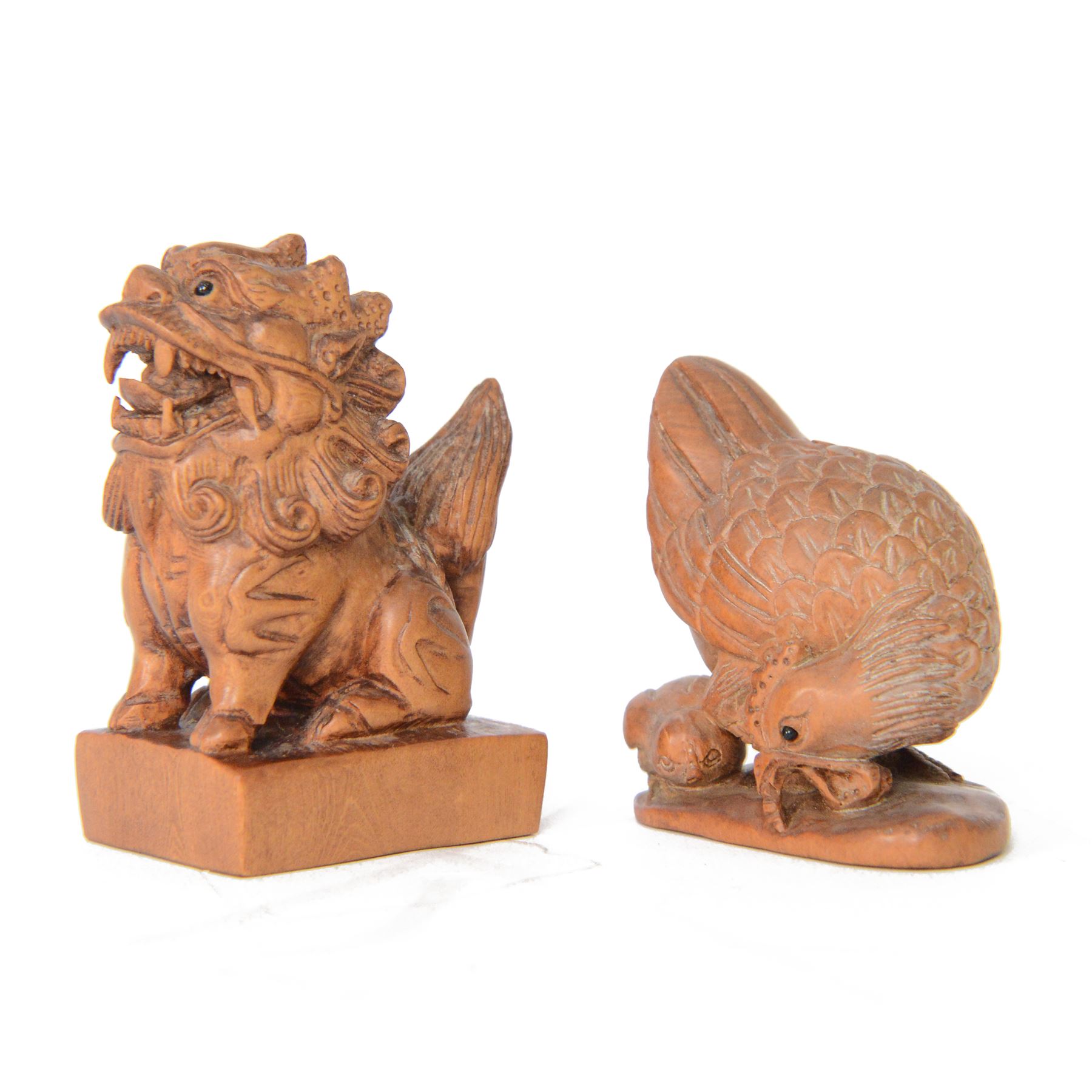  Two wooden netsuke, in the forms of a foo dog and a chicken, both signed to the base, H6cm