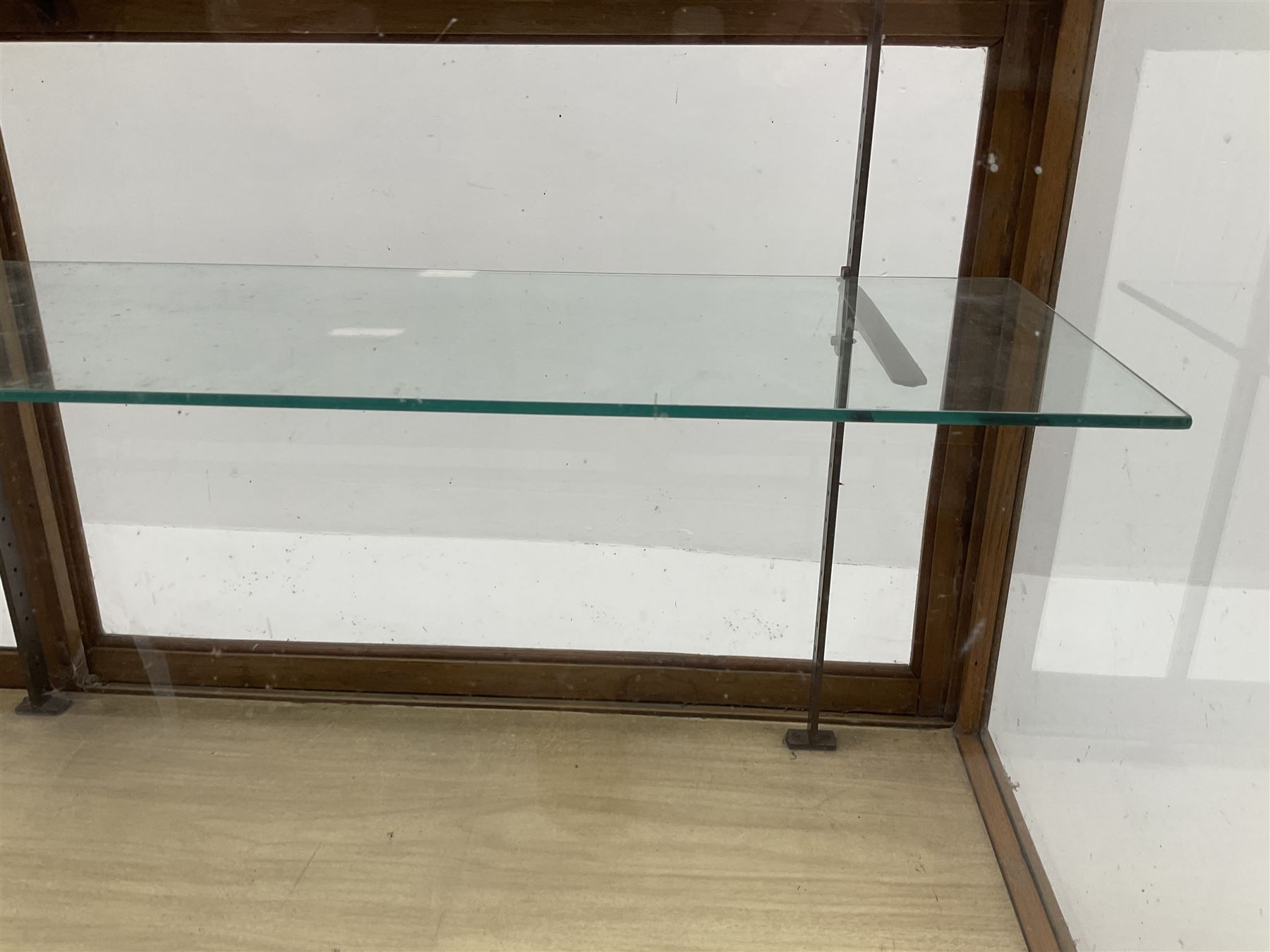 Mid century oak framed glazed display counter, two sliding doors, glazed shelves W182cm, H91cm, D61cm