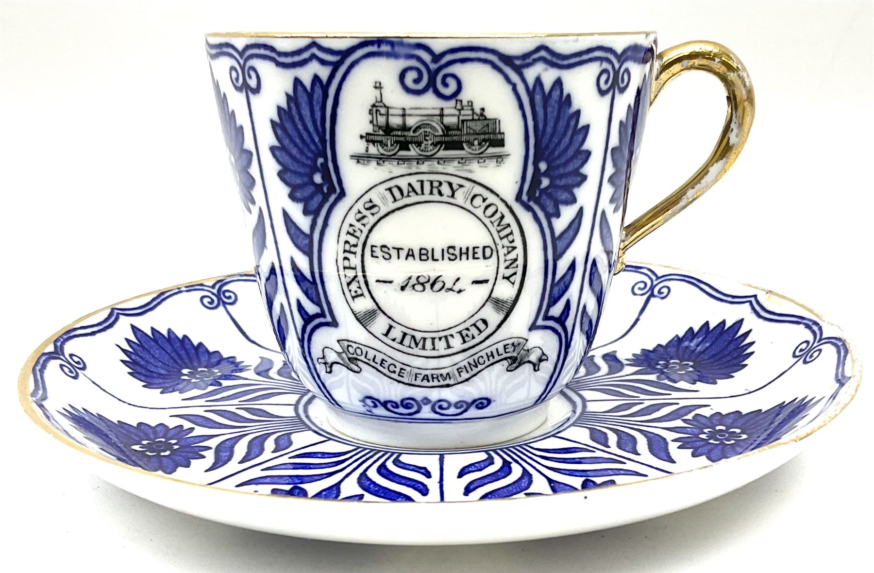 Late 19th century Coalport porcelain cup and saucer in the 'Aster' pattern bearing the crest of Express Dairy Company Limited, College Farm, Finchley and decorated with a steam locomotive