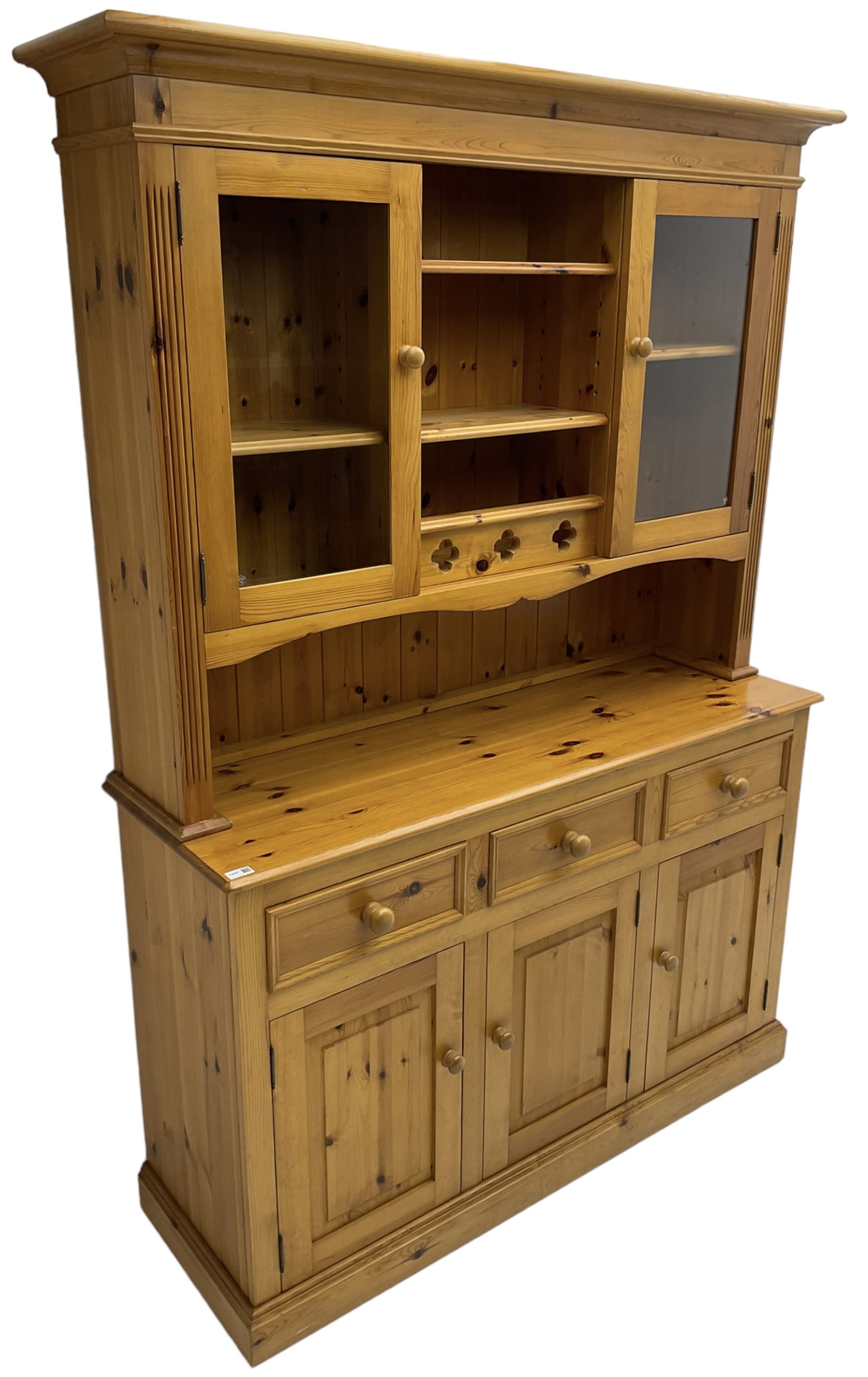 Traditional pine dresser, the rack fitted with two shelves flanked by glazed cupboards, the base with three drawers over three panelled cupboards