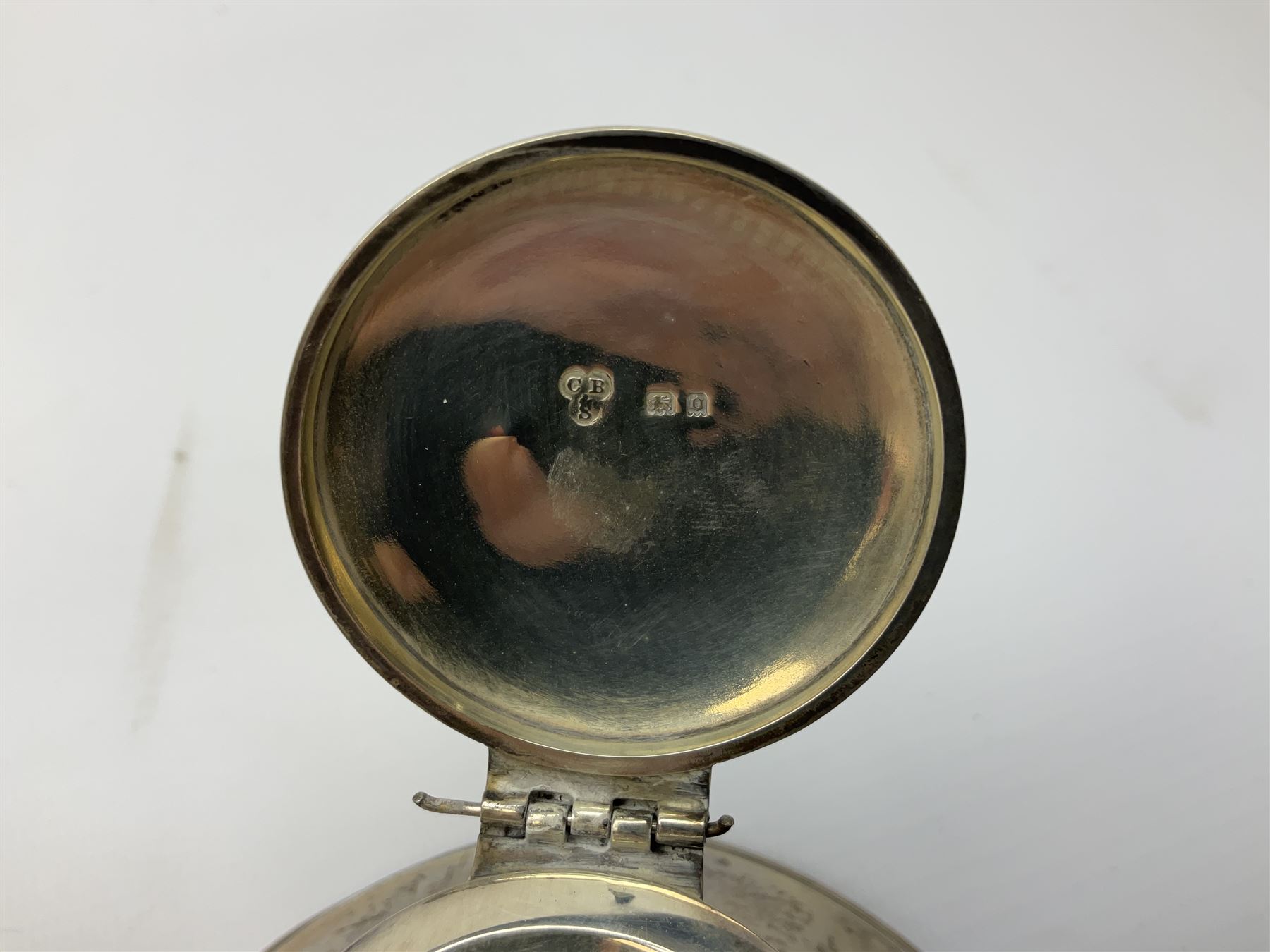 1920's silver mounted capstan inkwell, hallmarked Charles Boyton & Son Ltd, London 1929, together with an early 20th century silver mounted dwarf candlestick, hallmarked A J Pepper & Co, Birmingham 1918