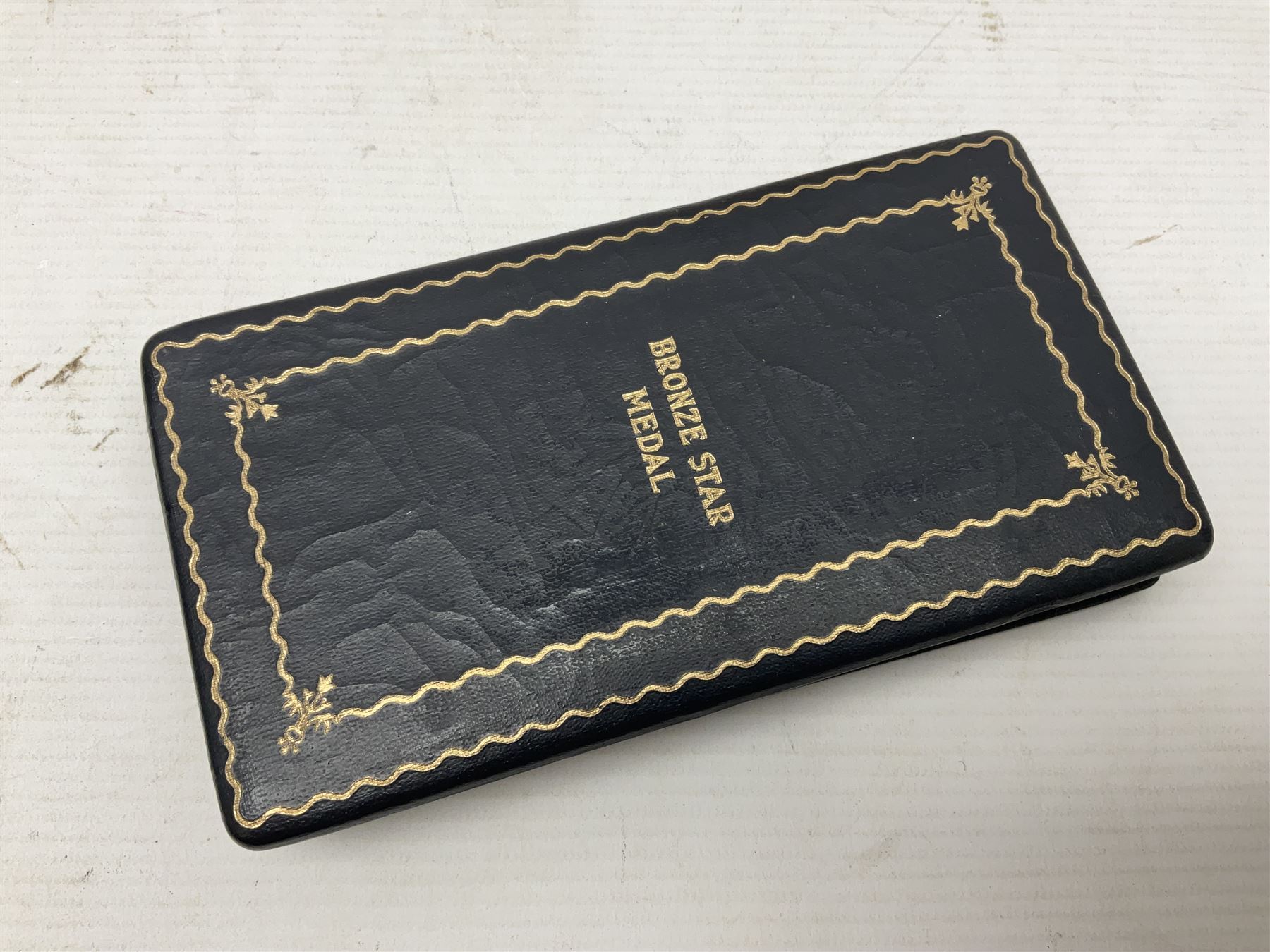 American Purple Heart Medal awarded to 32634848 Charles H. Poppo; cased with identity tags and paperwork; and Bronze Star Medal awarded to U.S. Marine Esteban T. Maranao; cased; American WWII Victory Medal and Asiatic Pacific Campaign Medal