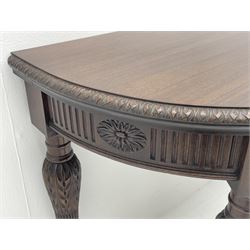 Pair early 20th century Hepplewhite style mahogany D-end console tables, the curved top with foliate carved edge, fluted frieze rails carved with flower heads, turned and reeded acanthus supports with recessed castors