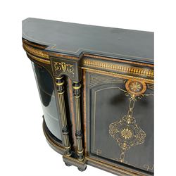Victorian ebonised and inlaid credenza, break-front with curved ends, the front fitted with two curved glazed doors and central panelled door, inlaid with scrolling foliate and star motifs, quadruple turned and fluted pilasters to front, gilt egg and dart moulded edge on plinth base with figured walnut band, on turned feet