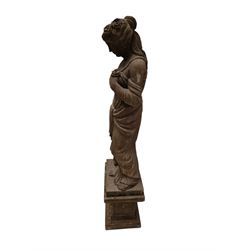 Hand carved stone Neoclassical figure of the Roman goddess Flora, her hair pinned with roses, draped in a toga, holding a basket of flowers in her right hand, raised on a stepped square plinth base 