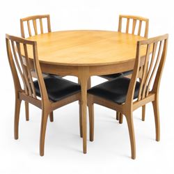 Sutcliffe of Todmorden - mid 20th century ‘S-Form’ teak dining table and chairs, the circular storable extending table with plain veneered top on tapered supports, together with matching dining chairs upholstered in black vinyl, with curved slat backs and shaped front supports, reflecting the sleek organic styling characteristic of 1960s British modern furniture design (Chairs H 93cm, W 46cm, D 46cm) (Extended 168cm)