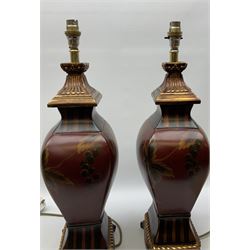 Pair Oriental table lamps decorated with birds in a tree with fruit, on a red ground with a gilded base together with cream lampshades H57cm, without lampshade. 