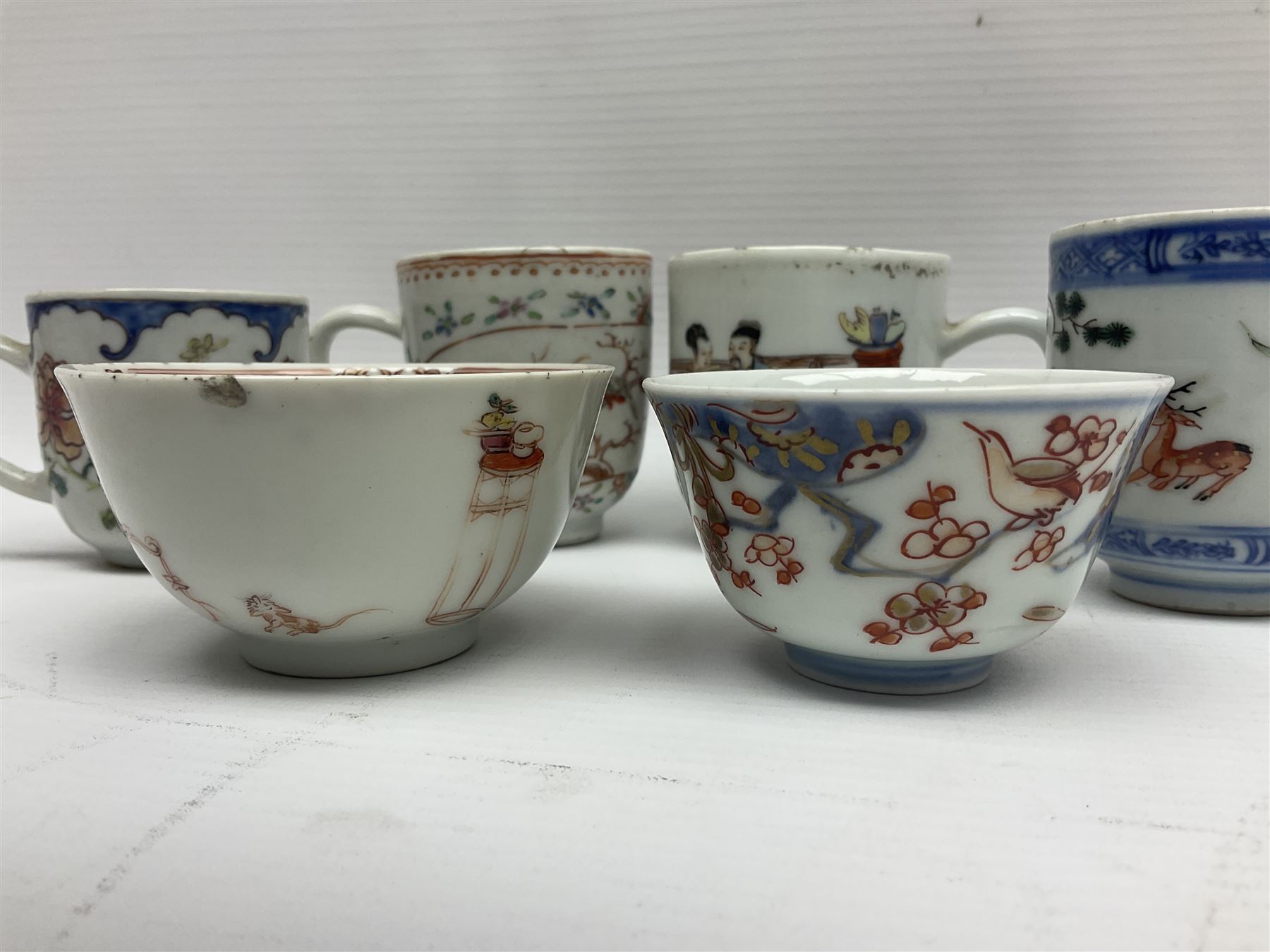 Two 18th century Chinese Yongzheng coffee cups, the first example decorated in polychrome enamel with rooster amidst blossoming peonies, the second decorated with deer and crane among rockwork and pine tree, together with two further 18th century Chinese coffee cups, an 18th century Chinese tea bowl, and a further tea bowl