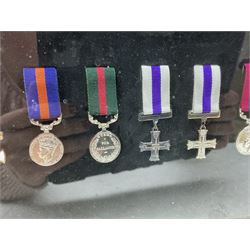 Limited edition large framed display board with sixty half-size copies of British Gallantry and Campaign Medals produced by Danbury Mint; all with ribbons and associated booklet