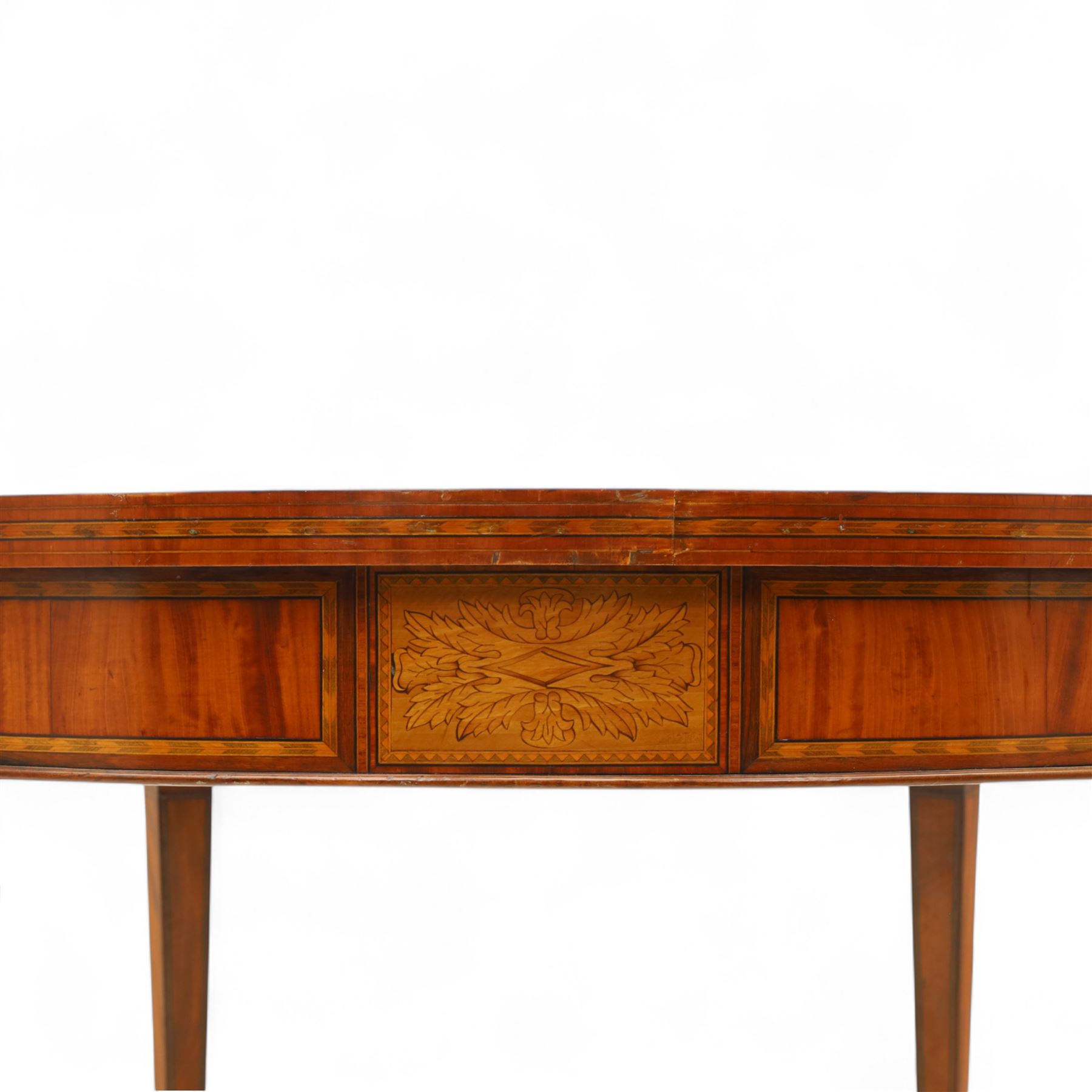 Aldam Heaton & Co (fl.1878-97) - late 19th century Sheraton revival style satinwood inlaid oval centre table, raised inlaid edge, centre with finely executed large central  inlaid medallion, surrounded by ribbon tied swags interspaced with medallions, frieze with rectangular symmetrical panels of foliate sprays of acanthus leaves, raised on four square section tapering legs with cavetti shaped shoulders with stringing on brass bulb feet, underside with bone plaque signed Aldam Heaton & Co, Baker St, London