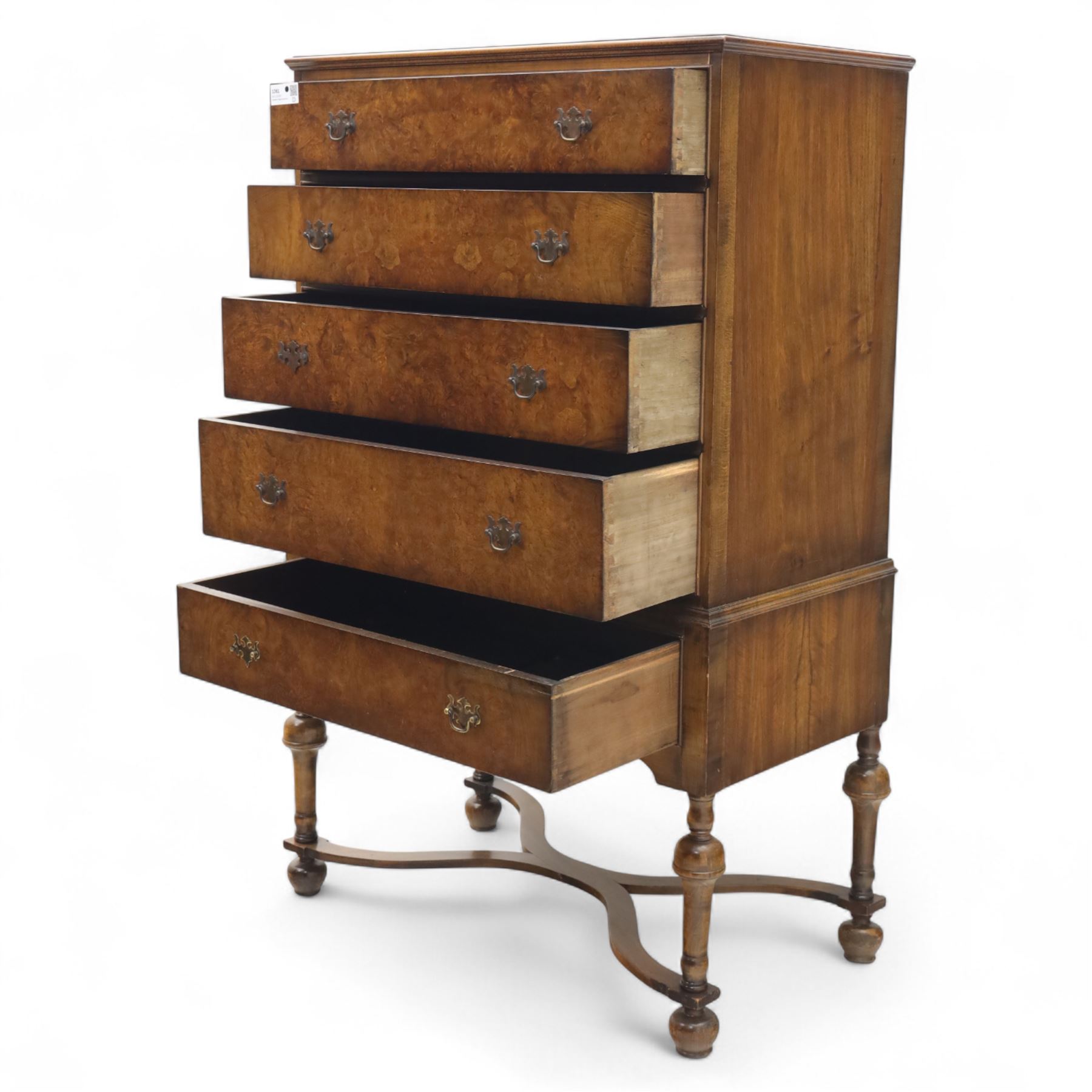 Georgian style walnut chest on stand, the figured top section fitted with four long drawers above a further drawer on the base, brass swan-neck handles, on turned legs joined by shaped stretchers with bun feet