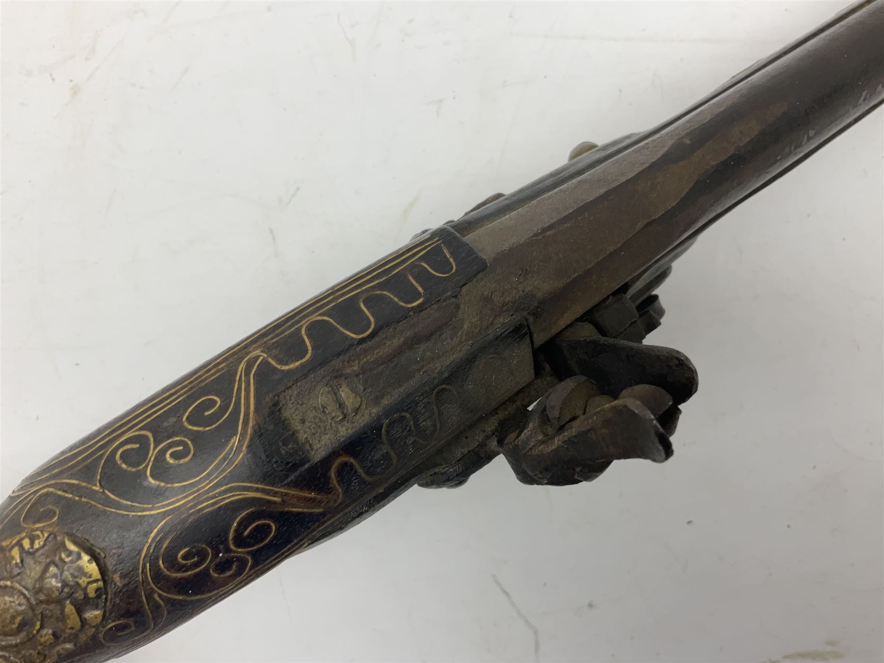 REGISTERED FIREARMS DEALERS ONLY - Reproduction flintlock pistol, the full walnut stock with brass filigree inlay and mounts and skull crusher butt L46cm; no visible proof marks - Disposed 25.06.25 - Notified 24.07.25