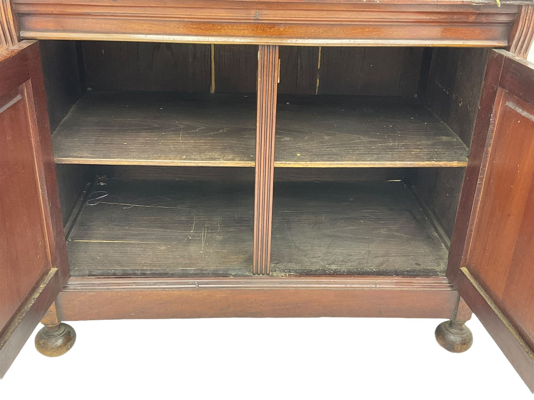 The Shannon Limited - late Victorian walnut filing cabinet, fitted with twenty-four small filing drawers, each with brass handle with label holder, fluted uprights, double cupboard below enclosed by two panelled doors, on turned feet, with brass plaque inscribed 'The Shannon, Limited, Ropemaker St. London, E.C.'