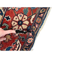 Persian blue ground carpet, the field divided up into panels by trailing bands with flower heads, each panel decorated with palmettes and stylised plant motifs, the border decorated with further palmettes, within floral pattern guard stripes 