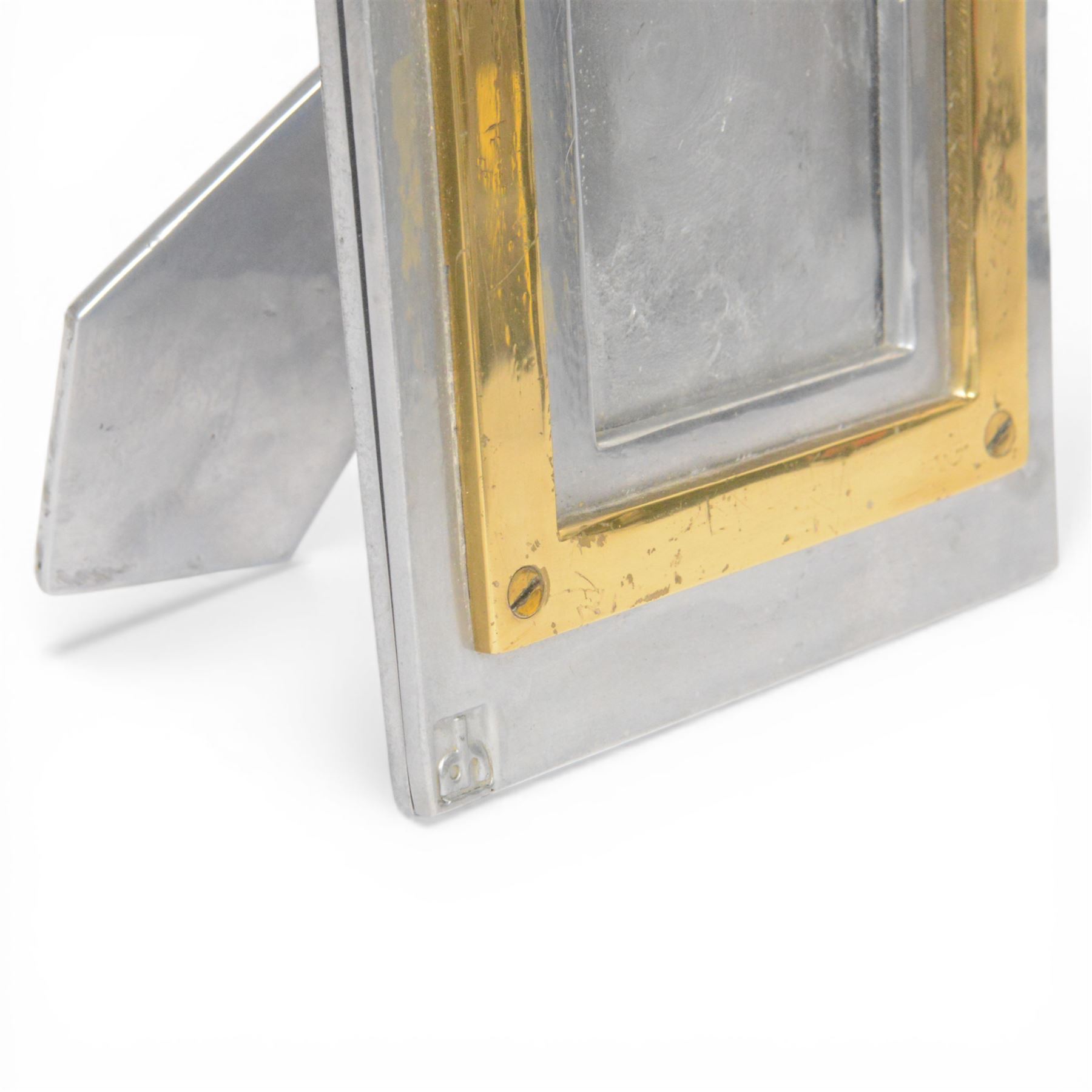 David Marshall photo frame, of cast aluminium mounted with a smaller brass frame, the maker's mark impressed to the lower left hand corner, H23cm