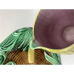 A Victorian majolica bread plate depicting corn within a woven basket, L33cm, together with a Victorian majolica jug modelled in the form of a corn cob, with registration mark beneath, H22cm. 