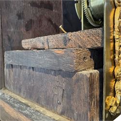 Henry De La Feuille of London-early 18th century marquetry 8-day longcase clock c 1720, hood with a moulded upstand to the domed caddy top, set on a lower upstand above a wide cornice with a marquetry frieze beneath, square hood door with marquetry inlay and attached three-quarter columns with wooden capitals, hood sides with glazed panels, trunk and door inlaid with figural marquetry with various representations of people, birds, scrollwork and foliage, full length door with cock-beading surround and a circular glazed lenticle, the case sides veneered with bordered panels within crossbanded surrounds, plinth with a convex moulding and shallow moulded skirt, brass dial with a matted centre and ringed winding holes, date aperture and seconds dial, silvered chapter with Roman numerals, five minute Arabic’s, minute and inner quarter hour tracks and half-our markers, with pierced steel hands and matching cast scroll spandrels depicting angels supporting a crown, dial pinned directly to a four pillar movement with an outside countwheel and recoil anchor escapement, striking the hours on a cast and polished bell.
With weights, pendulum and key.

Henry De La Feuille was a French Huguenot, born in 1670, moving to Jersey c1690 and finally London where he is thought to have died c1730.
