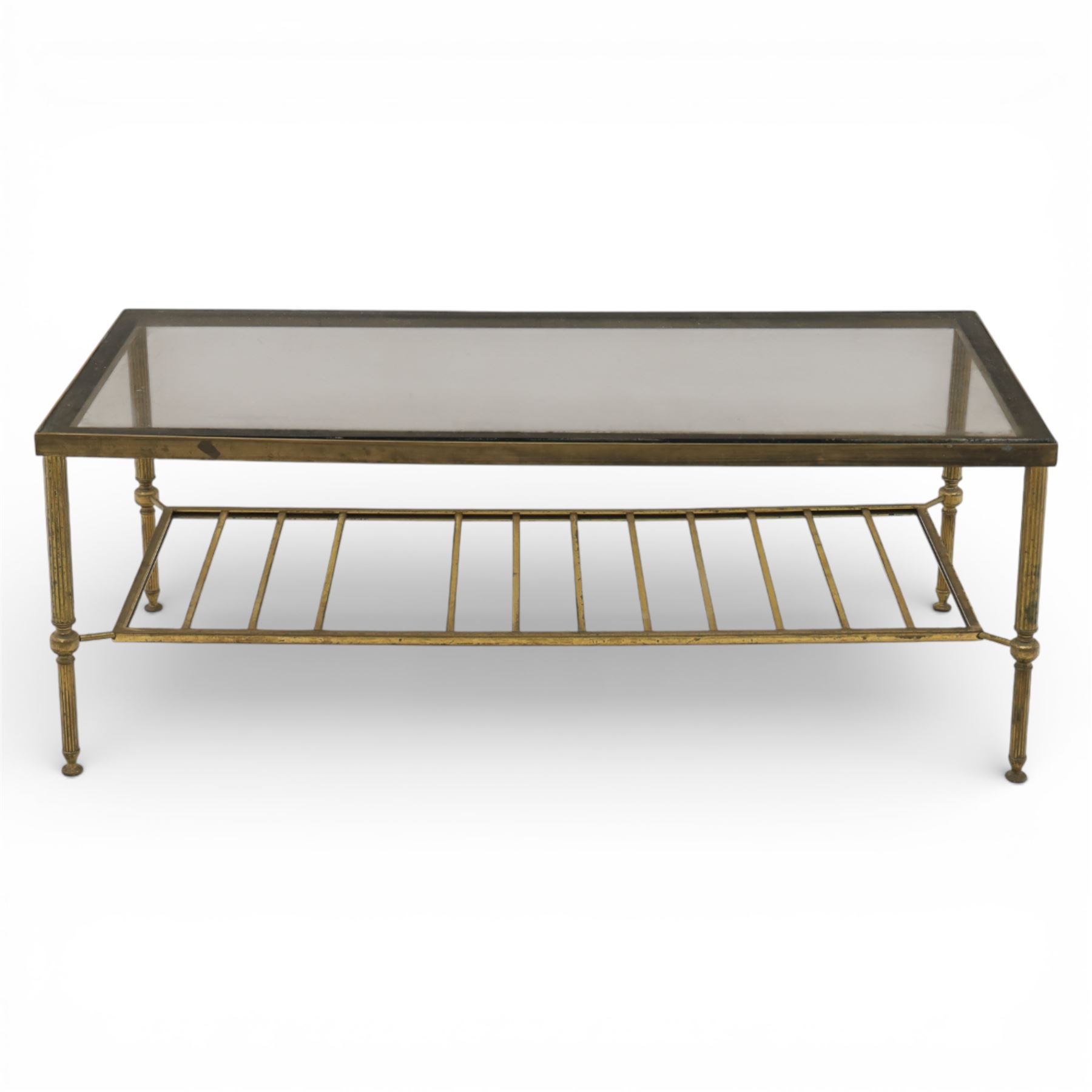 20th century brass and glass topped coffee table, the rectangular glass top within brass frame, upon four reeded legs united by lower slatted under tier 