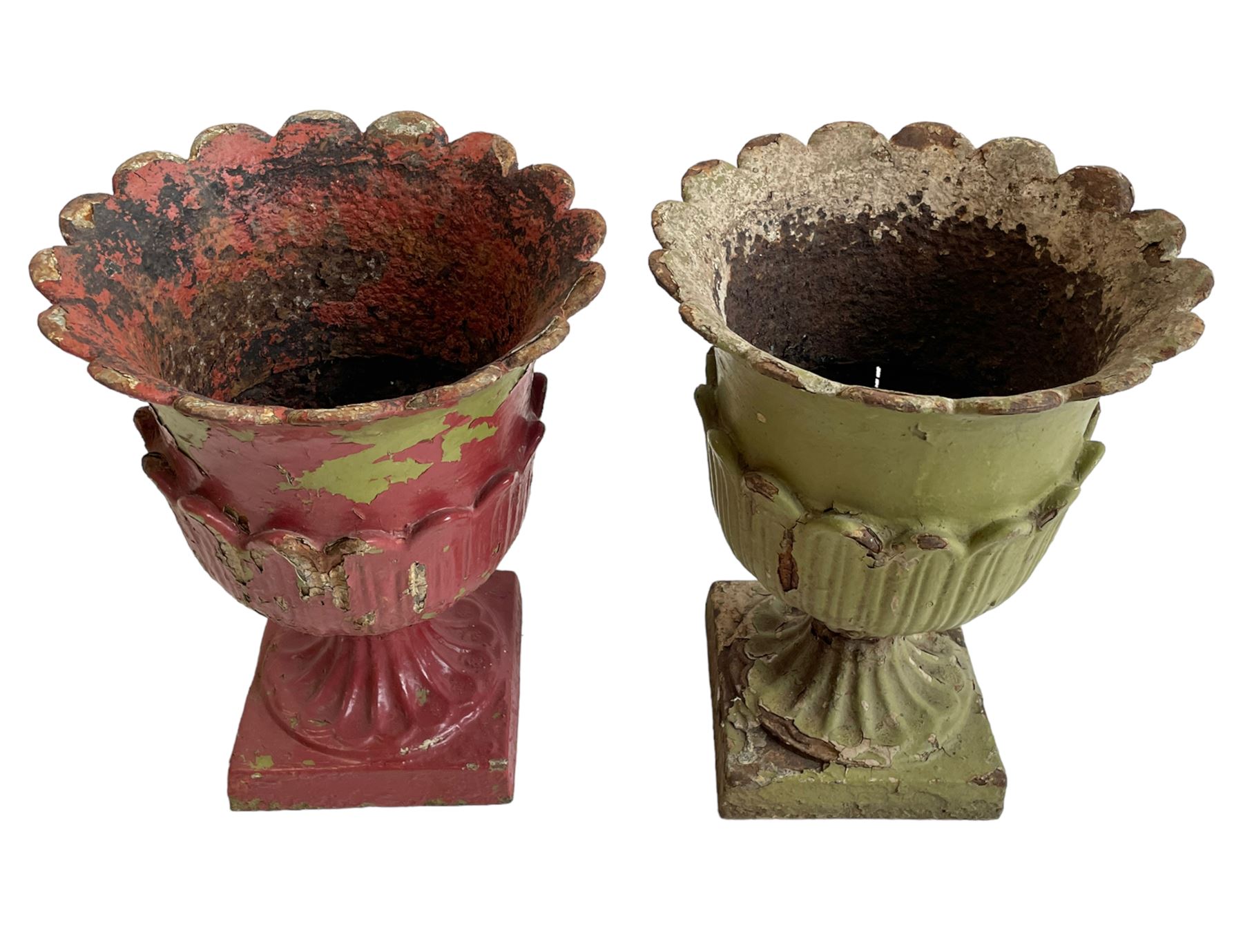 Pair of Victorian cast iron lotus garden urns, the shaped rim over lappet cast underbelly, on moulded footed base