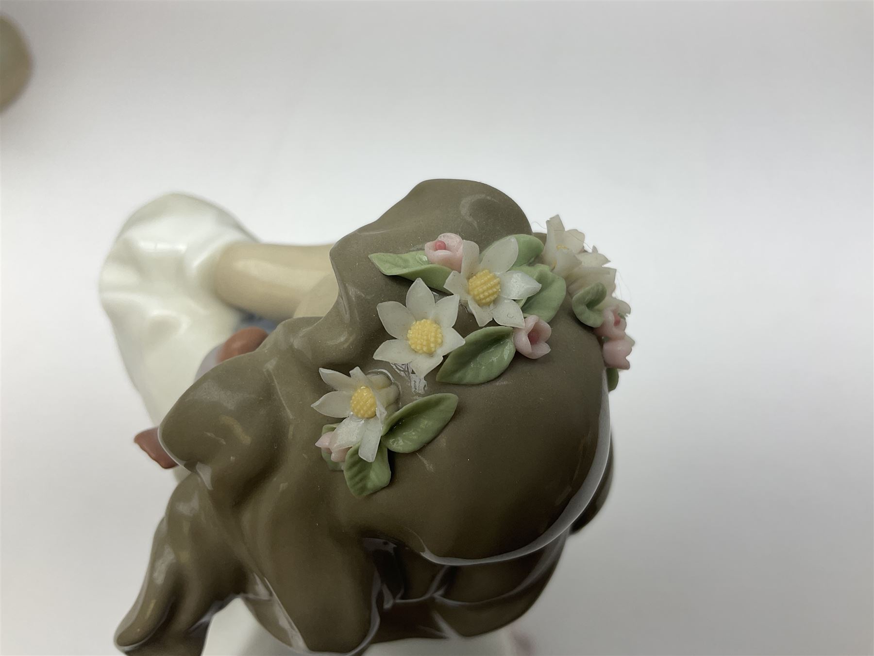 Three Lladro figures, comprising, Dreams of Summer Past no 6401, Spring Breeze no 4936 and Breezy Afternoon 5682 together with Lladro plaque Art Brings us Together no 7677, all in original boxes, largest example H35cm