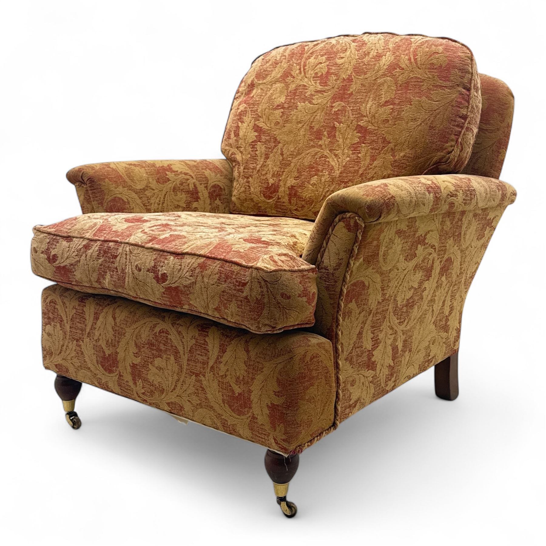 Duresta - Contemporary pair of upholstered armchairs, in red and gold damask style fabric, each with sprung seat and removable cushion back, rolled arms, on turned front supports with brass castors, square back legs 