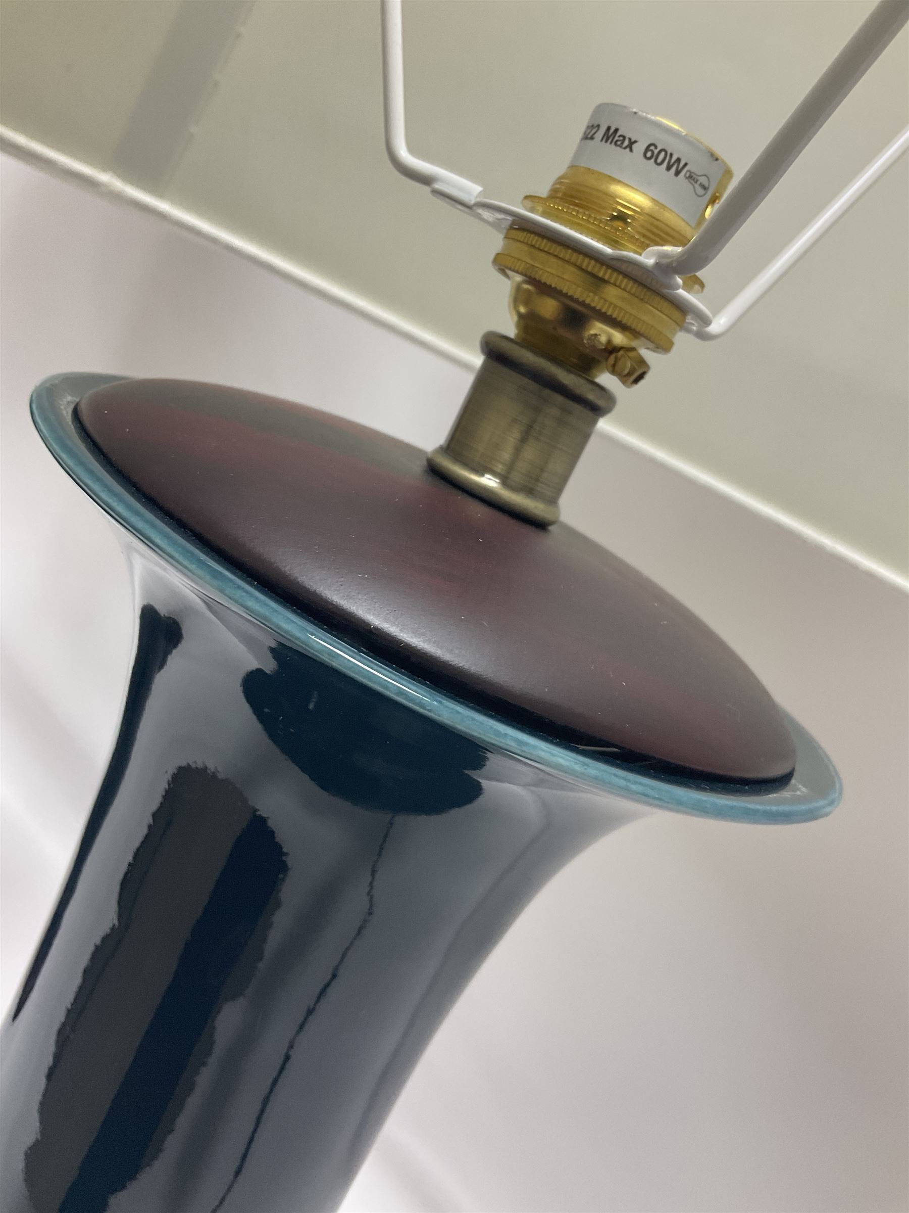 Pair of Chinese teal glazed table lamps, each of bottle form, raised upon circular hardwood bases, including shade H72cm 