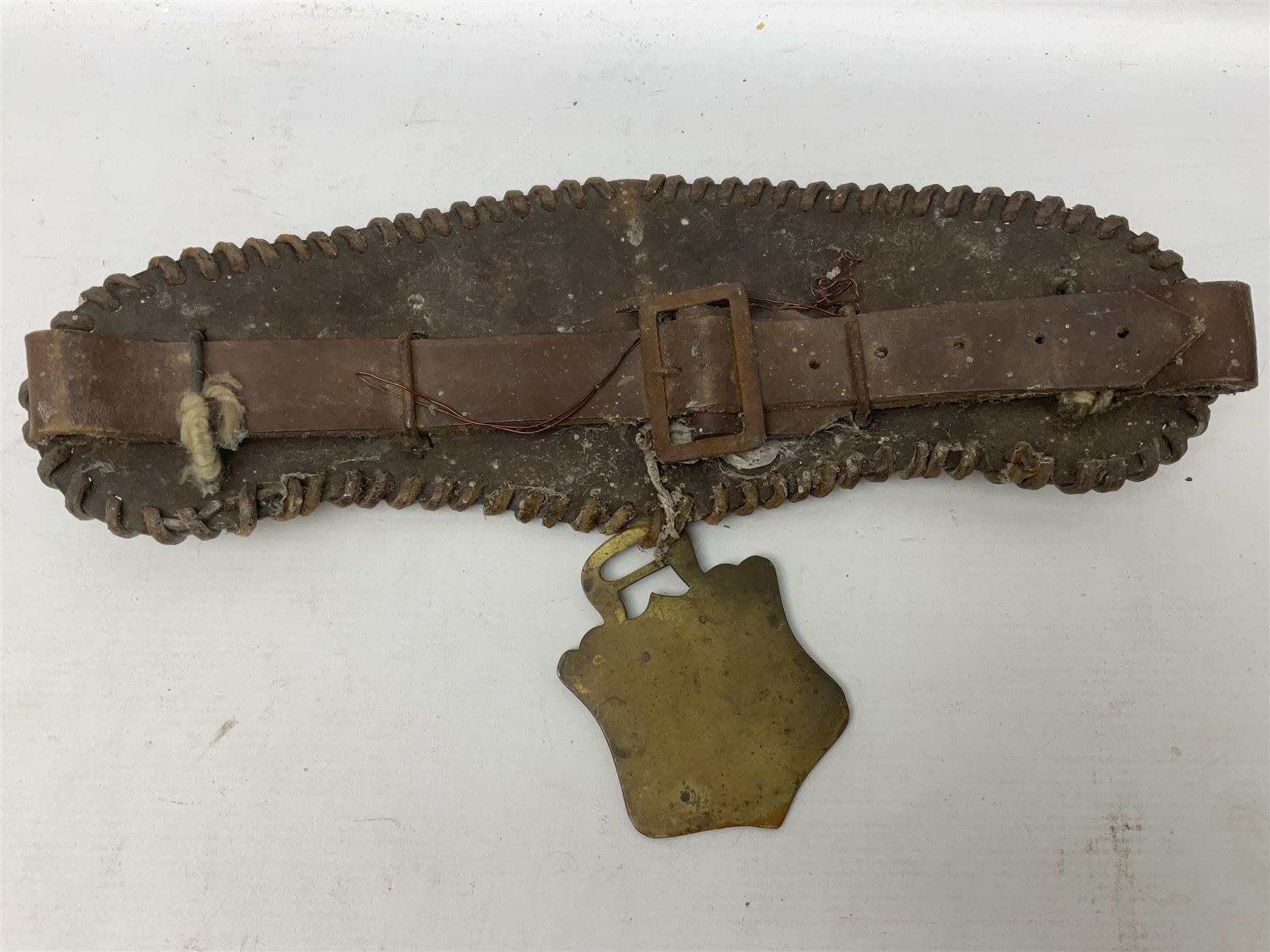 Victorian Queen Victoria record reign horse brass and H&SNCC Parade Badge of Merit 1911 horse brass, both on leather strap, together with 1924 British Empire Exhibition brass Lipton's souvenir tea caddy, strap L36cm