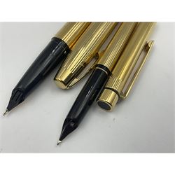 Sheaffer Triumph Imperial fountain pen, the gold plated barrel with fluted stripe design and gold nib stamped 14K 585, together with a Sheaffer Targa slimline fountain pen with gold plated barrel similarly decorated with gold nib stamped 14K 585, ballpoint pen and propelling pencil, each with a fluted gold plated barrel, largest L13.5cm (4)