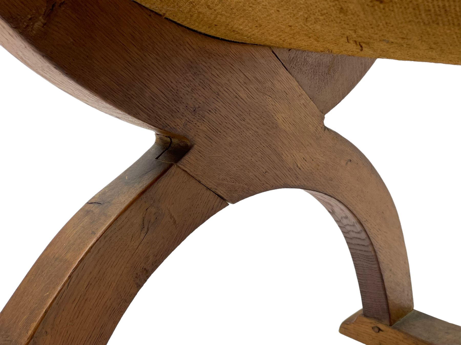 'Gnomeman' oak curved x-framed throne chair, sloped arched cresting rail carved with arcade, studded slung leather seat, the supports joined by sledge feet, rear upright carved with gnome signature, by Thomas Whittaker of Littlebeck