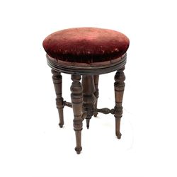 Mahogany swivel stool, seat upholstery in a wine red fabric, turned supports and stretchers