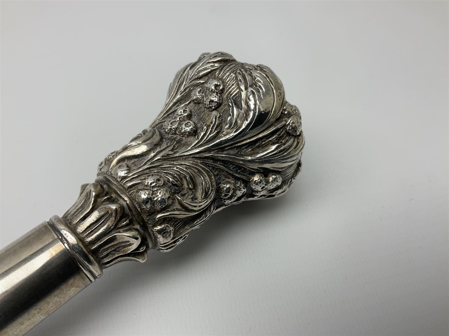 Silver topped walking cane, with embossed decoration in the Victorian taste of flowers, berries and acanthus leaves, stamped 925, upon an ebonised shaft, L94cm
