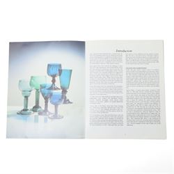 Five green wine glasses of early 19th century design with conical bowls and double knop stems on a circular foot, with pontil marks, pair of green wine glasses with chamfered stems together with an Asprey catalogue of green glass 1740-1840 and two pieces of glass fruit and leaves