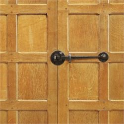 Mouseman - early-to-mid-20th century panelled and adzed double wardrobe, the arcade carved cresting rail over two panelled doors, with wrought metal hinges and latch, deep relief carved mouse signature, the interior fitted with hanging rail, by the workshop of Robert Thompson of Kilburn