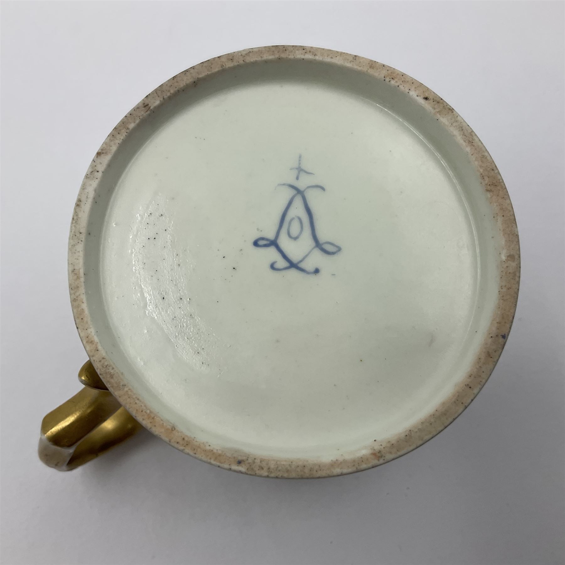 Sèvres soft paste porcelain coffee can and saucer with date code for 1767, painted with floral and laurel leaf garlands within blue scalloped and gilt borders, interlaced LL monogram enclosing the date letter O above painters mark for Catrice, coffee can H7.5cm, saucer D15cm