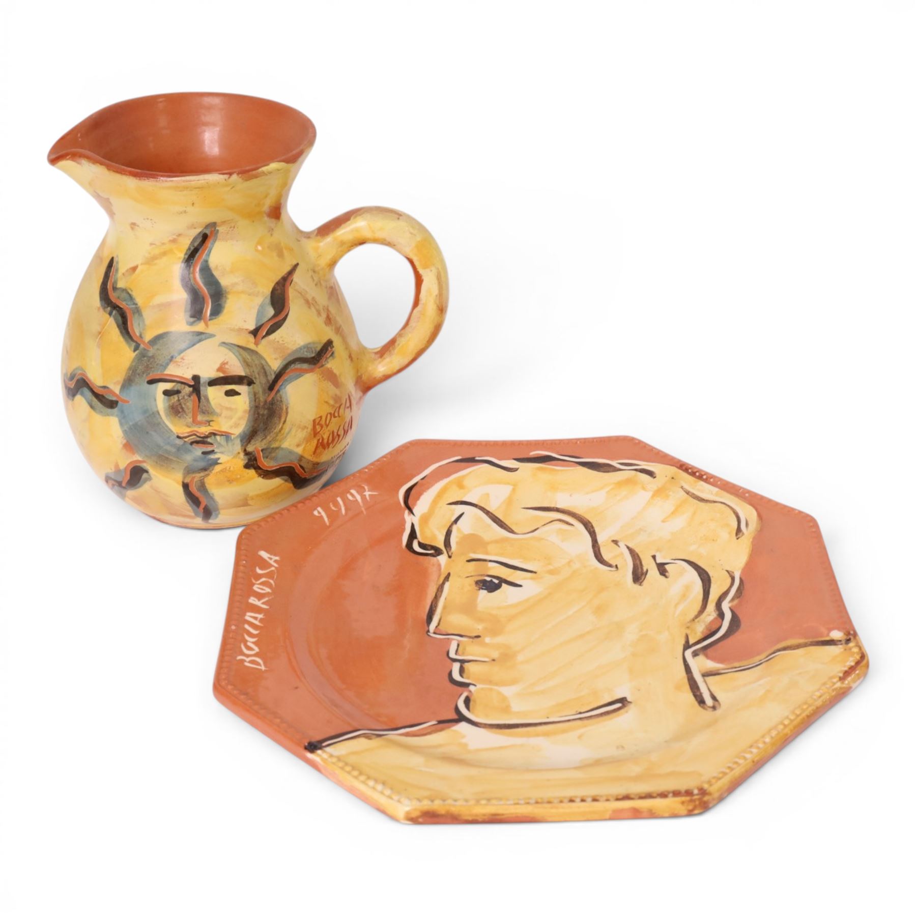 Vallauris French pottery by Patrick Bocca Rossa, jug painted with sun motifs upon a yellow ground, and an octagonal plate with a face to the center, both signed, jug H22cm 