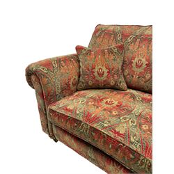 Duresta - 'Beaminster' grande two-seat sofa, traditional shape with rolled arms, upholstered in 'Althorp' russet and stone floral pattern fabric, on turned feet with brass castors
